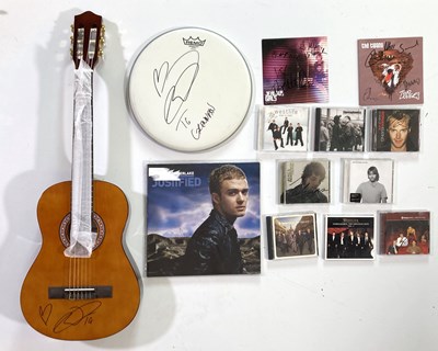 Lot 277 - POP STARS - SIGNED ITEMS INC A GUITAR AND DRUM SKIN.