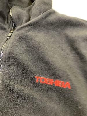 Lot 134 - OASIS - TOSHIBA BRANDED FLEECE AND 2000 TOUR ITINERARY.