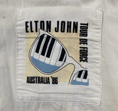 Lot 352 - ELTON JOHN - A 1986 TOUR SHIRT OWNED AND WORN BY ELTON JOHN.