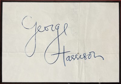 Lot 145 - THE BEATLES - A CUTTING SIGNED BY GEORGE HARRISON.