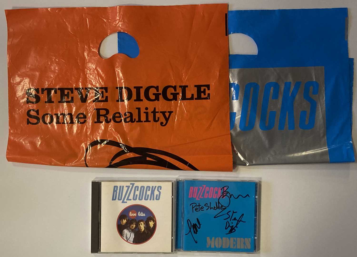 Lot 305 - BUZZCOCKS SIGNED CD AND MERCHANDISE BAGS