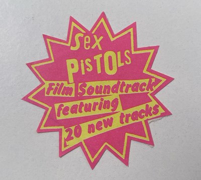Lot 114 - THE SEX PISTOLS - HOLIDAYS IN THE SUN - ORIGINAL POSTCARD AND STICKER.