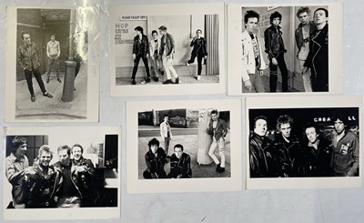 Lot 169 - THE CLASH - STAMPED ORIGINAL PRESS PHOTOS INC ONE SIGNED BY PAUL SIMONON.