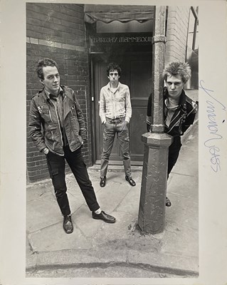 Lot 169 - THE CLASH - STAMPED ORIGINAL PRESS PHOTOS INC ONE SIGNED BY PAUL SIMONON.