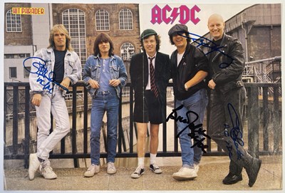 Lot 418 - AC/DC SIGNED MAGAZINE PAGE.