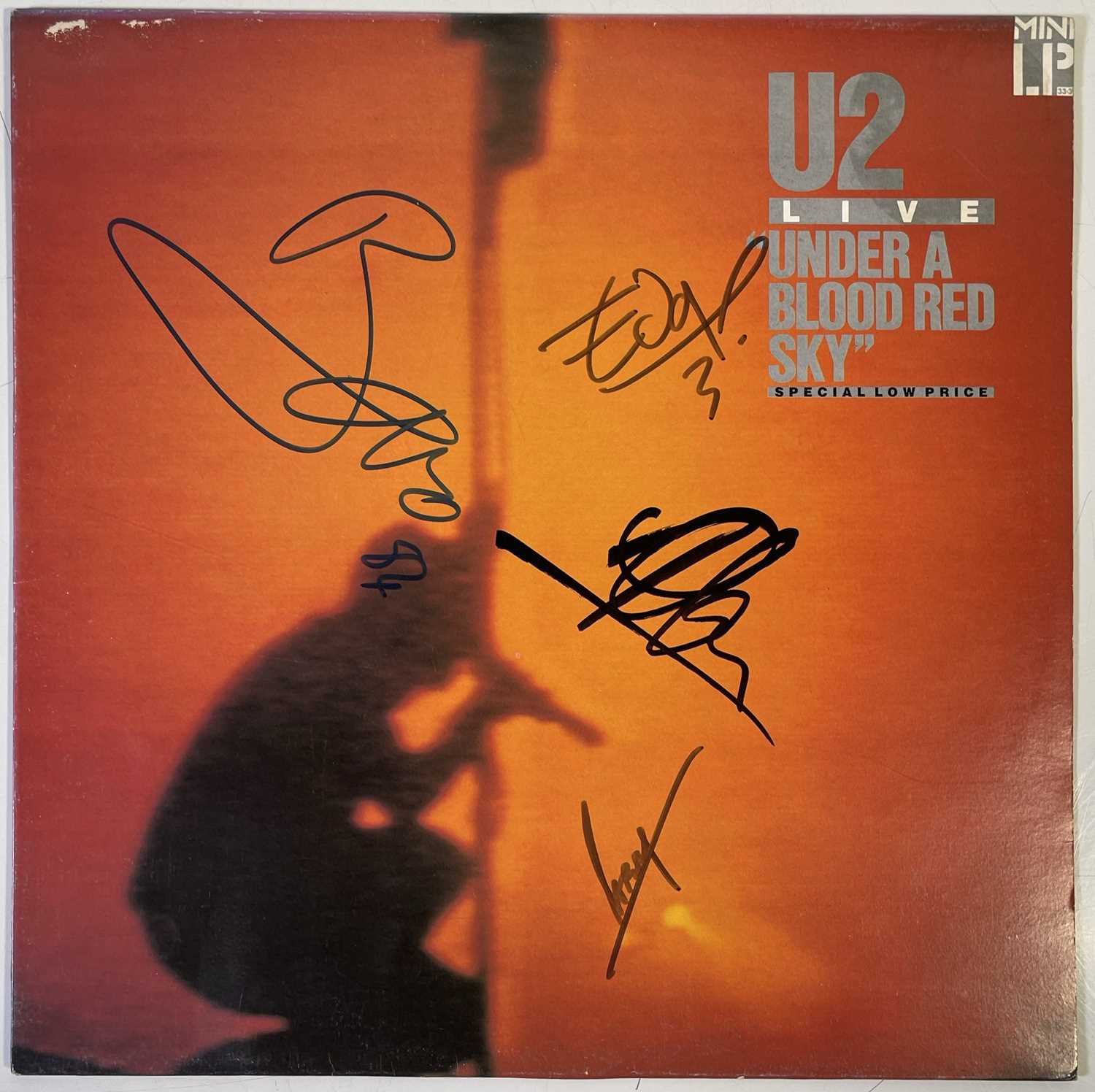 Lot 442 - U2 - SIGNED COPY OF 'UNDER A BLOOD RED SKY'.