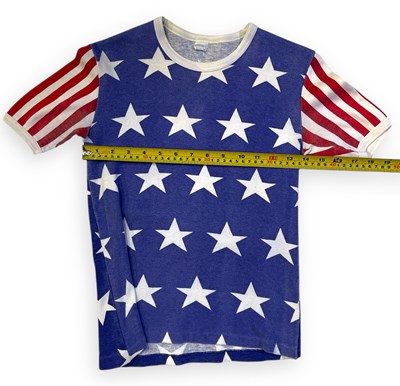 Lot 545 - QUEEN - A STARS AND STRIPES T-SHIRT OWNED AND WORN BY FREDDIE MERCURY.