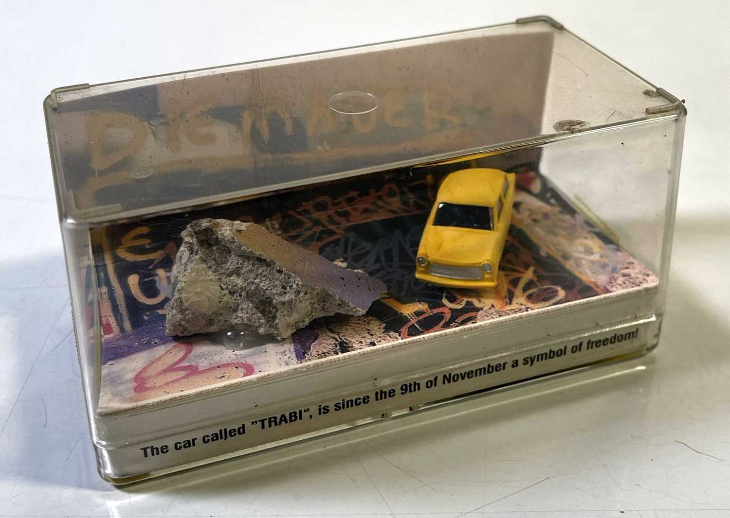 Lot 400 - U2 ACHTUNG BABY - PIECE OF BERLIN WALL IN TRABANT DISPLAY.
