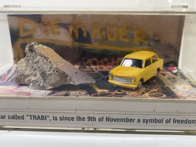 Lot 400 - U2 ACHTUNG BABY - PIECE OF BERLIN WALL IN TRABANT DISPLAY.