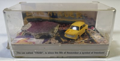 Lot 101 - U2 ACHTUNG BABY - PIECE OF BERLIN WALL IN TRABANT DISPLAY.