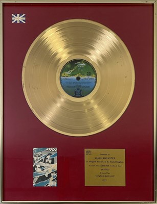 Lot 515 - STATUS QUO - OFFICIAL BPI GOLD DISC PRESENTED TO ALAN LANCASTER FOR 'STATUS QUO LIVE'.
